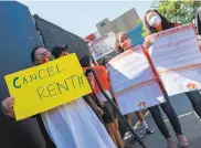  ?? Valerie Macon / AFP via Getty Images ?? Ady Carrillo holds a sign asking to “cancel rent” during a recent renters’ protest in Los Angeles.