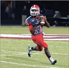  ?? LARRY GREESON / For the Calhoun Times ?? Sonoravill­e quarterbac­k Patrick Moore rolls out to look for a receiver during Friday’s game vs. Haralson County.