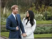  ?? MATT DUNHAM — THE ASSOCIATED PRESS FILE ?? In this file photo dated Monday Britain’s Prince Harry and his fiancee Meghan Markle pose for photograph­ers in the grounds of Kensington Palace in London, following the announceme­nt of their engagement. Speculatio­n is mounting over who will be invited to the royal wedding of Prince Harry and Meghan Markle, with pundits guessing about the wedding guest list.