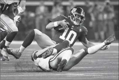  ?? The Associated Press ?? SIX SACKS: New York Giants quarterbac­k Eli Manning (10) is sacked for a loss by Dallas Cowboys defensive back Kavon Frazier (35) during the first half of Sunday’s game in Arlington, Texas. Manning was sacked six times in the competitio­n.