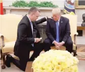  ?? JACQUELYN MARTIN/AP ?? President Donald Trump prays with American pastor Andrew Brunson on Saturday in the Oval Office. Brunson was freed Friday after nearly two years of detention in Turkey.