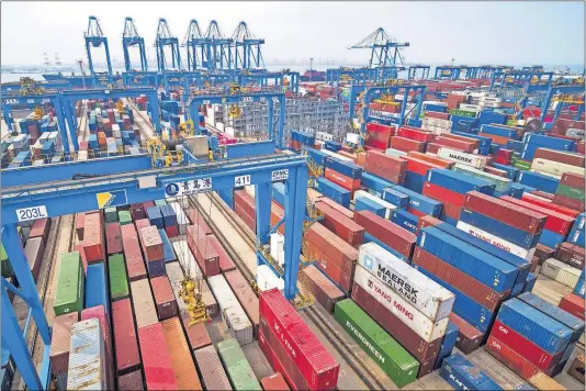  ?? [CHINATOPIX VIA AP] ?? Containers are piled up at a port in Qingdao in east China’s Shandong province. China’s imports from the United States plunged 31.4% in June from a year earlier amid a tariff war with Washington, while exports to the U.S. market sank 7.8%.