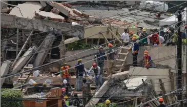  ?? The Associated Press ?? COLLAPSE: Search and rescue efforts continue Wednesday at the Enrique Rebsamen school that collapsed after an earthquake in Mexico City. Police, firefighte­rs and ordinary Mexicans dug franticall­y through the rubble of collapsed schools, homes and...