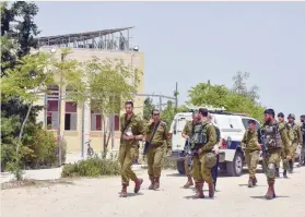  ?? (Dudu Greenspan/Flash90) ?? SECURITY FORCES arrive at the scene of an attempted stabbing attack by the synagogue in Teneh Omarim on Friday.