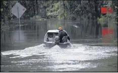  ?? GERRY BROOME / AP 2005 ?? Hunter Baker drives his boat to his home following heavy rains in Florence, S.C. Meteorolog­ists’ forecasts are getting more accurate.