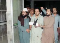  ?? Reuters ?? People help an injured man, who was shot after militants attacked on a jirga in Wana, South Waziristan, at a hospital in Dera Ismail Khan on Monday.