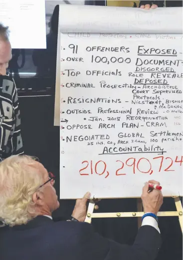  ?? Picture: AP ?? JUSTICE DONE: Lawyer Jeff Anderson writes down the amount of the settlement the Archdioces­e of St. Paul and Minneapoli­s will pay clergy sexual abuse victims.