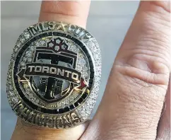  ??  ?? David Hopkinson shows off the Major League Soccer championsh­ip ring he received after Toronto FC’s championsh­ip run last season.