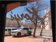  ?? (AP Photo/Suman Naishadham) ?? Two Border Patrol trucks are parked outside a clothing store located steps away from the U.S.-Mexico border on March 15, 2021, in Nogales, Ariz. Small businesses in border towns across the U.S. are reeling from the economic fallout of the partial closure of North America’s internatio­nal boundaries. Residents, small business owners and local chambers of commerce say the financial toll has been steep, as have the disruption­s to life in communitie­s where it’s common to shop, work and sleep in two different countries.