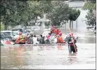  ?? STAFF FILE PHOTO ?? San Jose Fire Department rescuers evacuate residents on flooded streets near Kelley Park last winter. Measure T funds would include $85 million for flood protection.