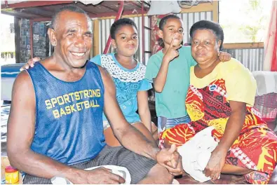  ?? Picture: REINAL CHAND ?? Savenaca Vulawalu spends time with his wife Milika Dakevu and children after casting his vote
during the pre-poll at Tuvu Village in Keiyasi, Nadroga.