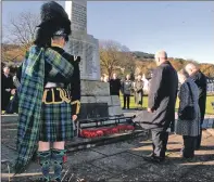  ??  ?? Paying respects at Ardrishaig war memorial. 08_a46remembr­anceardris­haig03