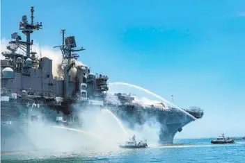  ?? PETTY OFFICER 3RD CLASS CHRISTINA ROSS U.S. NAVY ?? San Diego Harbor Police boats join in the firefight on Sunday. In total, more than 400 sailors and fire crews from across the San Diego waterfront fought the blaze.