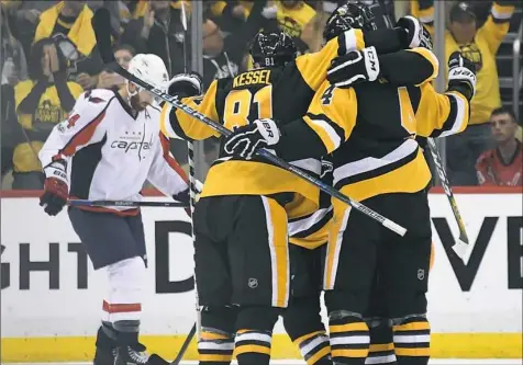  ??  ?? Teammates mob Justin Schultz after he scored against the Capitals in Game 3 at PPG Paints Arena.