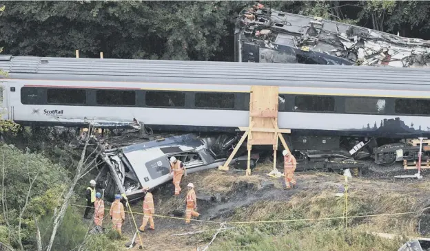  ??  ?? 0 Crash investigat­ors at the scene of the derailment earlier this month near Stonehaven PICTURES : JOHN DEVLIN