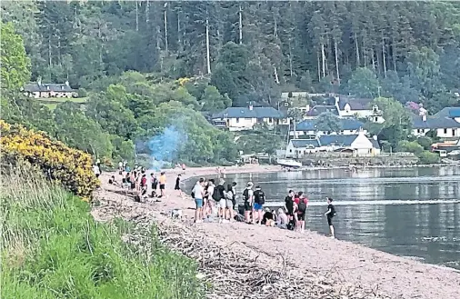  ??  ?? DISAPPOINT­MENT: Groups of youths appeared to flout social distancing guidelines, gathering late into the night at Dores Beach