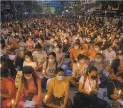  ?? AP file photo ?? Protesters attend a candleligh­t night rally in Yangon, Myanmar on March 13, 2021. The prospects for peace in Myanmar, much less a return to democracy, seem dimmer than ever two years after the army seized power from the elected government of Aung San Suu Kyi, experts say.
