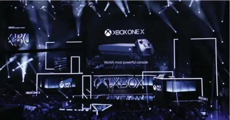  ?? CHRISTIAN PETERSEN/GETTY IMAGES ?? Microsoft introduces the Xbox One X during the company’s Electronic Entertainm­ent Expo briefing on Sunday in Los Angeles.