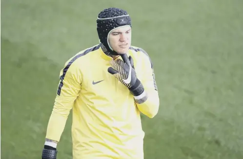  ??  ?? 0 Manchester City goalkeeper Ederson wears a protective helmet during training yesterday and will be assessed today.