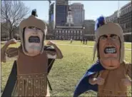  ??  ?? Trojan Men portrayed by Pottstown High School juniors Austin Andrews and Aaron Diamond at Independen­ce Mall Monday where they helped Mascots for a Cure kick off the Lace Up and Twist Away Childhood Cancer Tour.