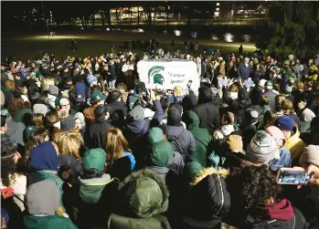  ?? SCOTT OLSON/GETTY ?? Students, faculty and others attend a vigil Feb. 15 at Michigan State University in East Lansing, Michigan.