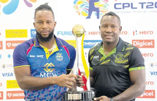  ?? CPLT20 ?? Kyle Mayers (left), captain of the Barbados Royals, and Jamaica Tallawahs skipper Rovman Powell pose with the Caribbean Premier League trophy.