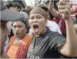  ?? — AFP ?? An activist shouts anti-Duterte slogans during a protest in Manila on Thursday.