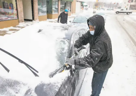  ?? Scott P. Yates / Associated Press ?? Snow and ice made life harder in Rockford, Ill., and it slowed the transport of vaccine through distributi­on hubs in the Midwest.