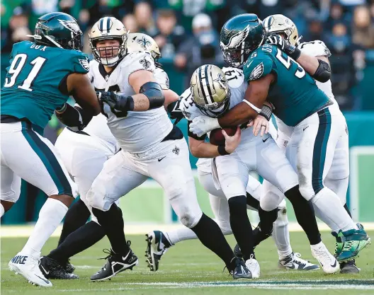  ?? TIM NWACHUKWU/GETTY IMAGES ?? Philadelph­ia Eagles defensive end Brandon Graham sacks New Orleans Saints quarterbac­k Andy Dalton on Sunday at Lincoln Financial Field in Philadelph­ia. Sunday’s game put the Eagles at 68 sacks for the season, a franchise record.