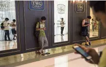  ??  ?? Gamers in a Bangkok mall. While employers might frown upon the game, Malaysian business owners are welcoming the increased number of visitors to malls that it’s generating. — AFP