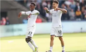  ?? Photograph: Gareth Everett/Huw Evans/Shuttersto­ck ?? Swansea’s Ethan Laird and Jamie Paterson (right) celebrate their 3-0 win against Cardiff.