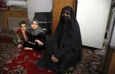  ?? Vahid Salemi, The Associated Press ?? Afghan refugee Zahra Husseini and her children Salehe, center, and Shahrzad sit in their room in a poor suburb of Tehran, Iran, on April 21.