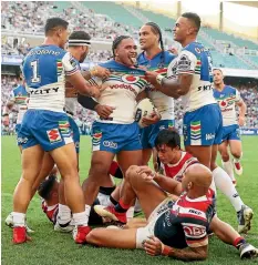  ?? PHOTO: GETTY IMAGES ?? Solomone Kata of the Warriors celebrates with team-mates after scoring a try against the Sydney Roosters at Allianz Stadium on Saturday.