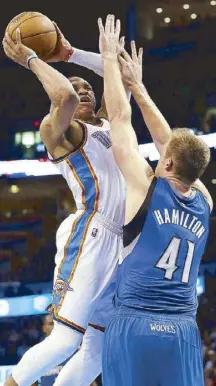  ?? AP ?? Oklahoma City Thunder guard Russell Westbrook shoots over Minnesota Timberwolv­es center Justin Hamilton in the fourth quarter in Oklahoma City.