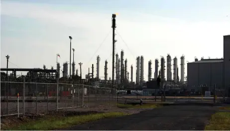  ?? — AFP photo ?? A flame burns at the top of petrochemi­cal plant in Houston, Texas. US oil prices rebounded back above zero on April 21, a day a er futures ended in negative territory for the first time as a coronaviru­s-triggered collapse in demand leaves the world awash in crude.