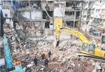  ??  ?? Firefighte­rs and rescue workers search for survivors at the site of a collapsed building in Mumbai, India. — Reuters photo