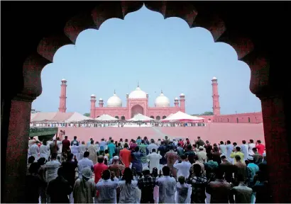  ??  ?? People offer Eid Al Fitr prayers at the historic Badshahi mosque in Lahore on Monday. —