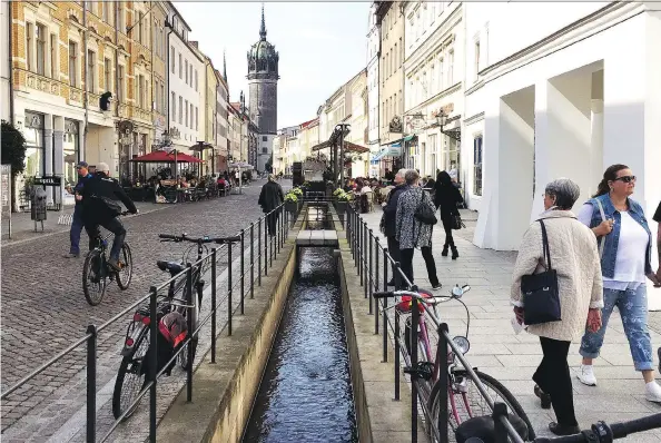  ?? PHOTOS: ELIOT STEIN/FOR THE WASHINGTON POST ?? A canal trickles toward Castle Church, where Martin Luther is said to have nailed his 95 theses to the door.