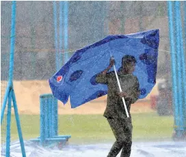  ?? — AFP ?? Afghanista­n’s training session on Wednesday was disrupted by heavy rain.