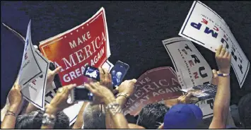  ?? AP ?? Supporters wave their signs toward Republican presidenti­al candidate Donald Trump as he greets the crowd after speaking at a rally in Manchester, N.H., on Thursday.