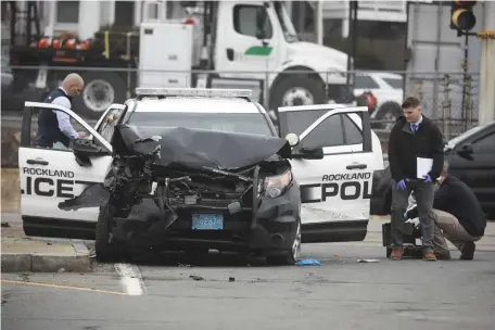  ?? NICOLAUS CZARNECKI / HERALD STAFF ?? BRAZEN CRIME: Police inspect a Rockland Police cruiser stolen Friday morning, resulting in a chase to Quincy and the fatal shooting of an armed robber. Below, SWAT vehicles and police are seen on the street in Quincy.