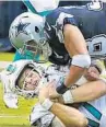  ?? CHARLES TRAINOR JR/TNS ?? Dolphins quarterbac­k Ryan Tannehill is tackled by Dallas’ Jeff Heath on Sunday.