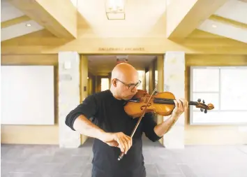  ?? Tyler Sizemore / Hearst Connecticu­t Media ?? Icli Zitella plays his violin at the Greenwich Historical Society in Cos Cob. Icli is part of an upcoming exhibit about settling in Fairfield County as an immigrant. He came to the U.S. from Venezuela in 2012.
