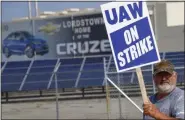  ?? KEITH SRAKOCIC - ASSOCIATED PRESS ?? A picketer carries sign Sept. 16 at one of the gates outside the closed General Motors automobile assembly plant in Lordstown, Ohio.