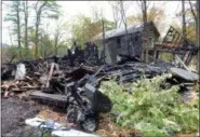  ?? TANIA BARRICKLO — DAILY FREEMAN ?? A pile of charred wood is all that remains of one of the three houses that burned in Woodstock, N.Y., on Monday.