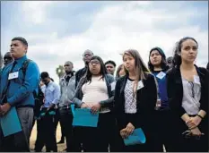  ??  ?? OFFICIALS and Metro interns at the ceremony. The project’s critics say the area needs restaurant­s and retail space, not a boarding school.