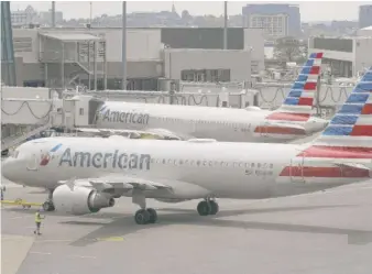  ?? STEVEN SENNE/AP ?? American Airlines passenger jets at Boston Logan Internatio­nal Airport. American says it plans to run at 95% to 100% of 2019 levels next year, in line with Delta.