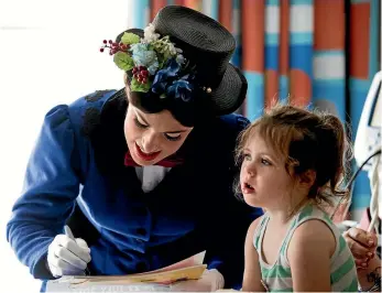  ?? PHOTOS: ANDY JACKSON/STUFF ?? Mary Poppins, aka Bryony Williams, signs a poster for Kera Olliver, 4.