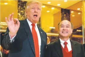  ??  ?? President-elect Donald Trump, accompanie­d by SoftBank CEO Masayoshi Son, speaks to members of the media at Trump Tower in New York on Dec. 6. Trump gave himself kudos for the creation of 8,000 new U.S. jobs by Japanese tech mogul Son, saying it was...
