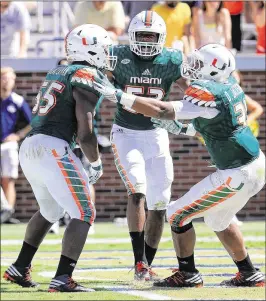  ?? DANIEL SHIREY/GETTY IMAGES ?? Shaq Quarterman is congratula­ted by teammates after he recovered a fumble for a touchdown against Georgia Tech last October. Quarterman was third among ACC freshmen in tackles (84) and had 10 tackles for loss last season.